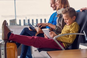 Happy family with freshly charged devices at Manchester airport
